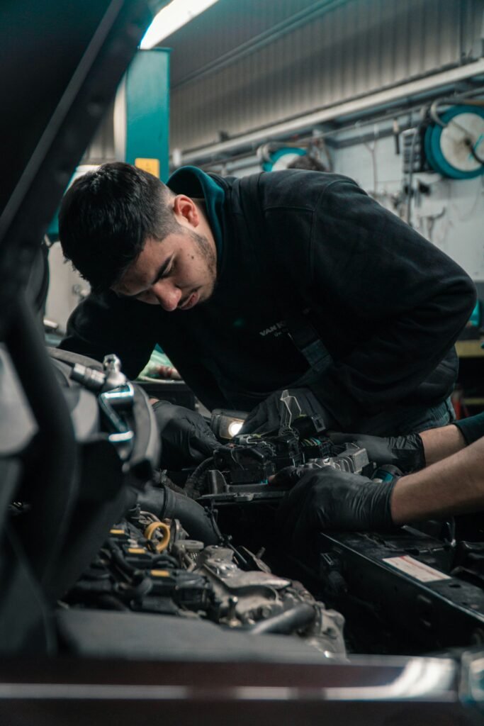Experienced mechanical inspecting repairing a vehicle engine