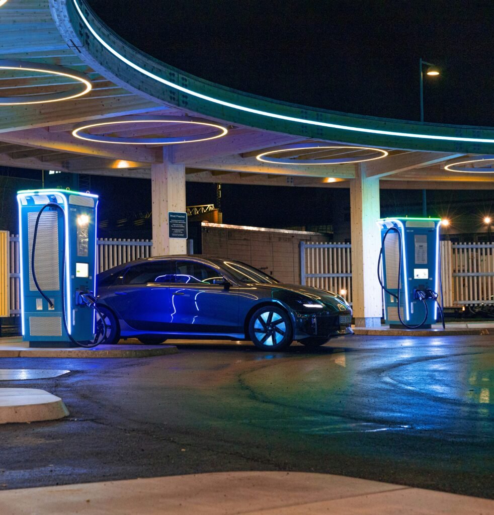 Blue luxury electric vehicle charging at an EV station
